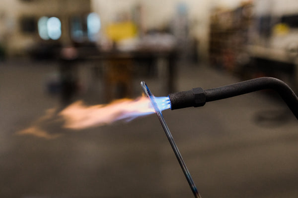 Torch firing on a steel metal pole
