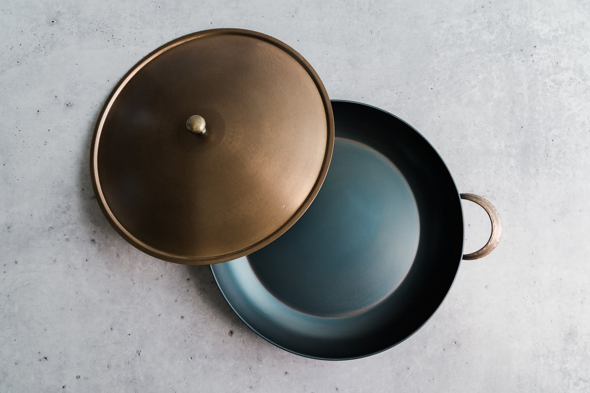 Handcrafted carbon steel saucier with bronze handles and stainless steel lid