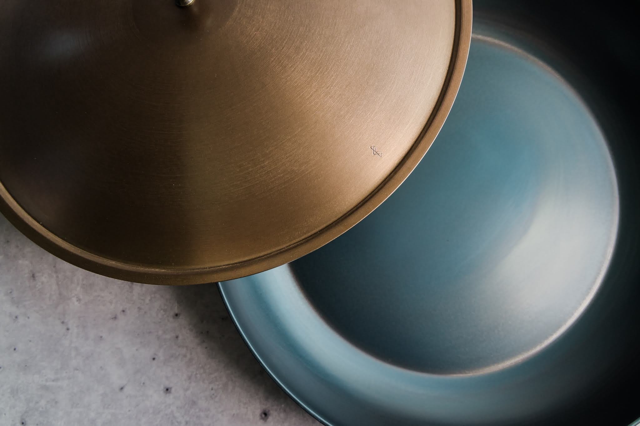 Handcrafted carbon steel saucier with bronze handles and stainless steel lid