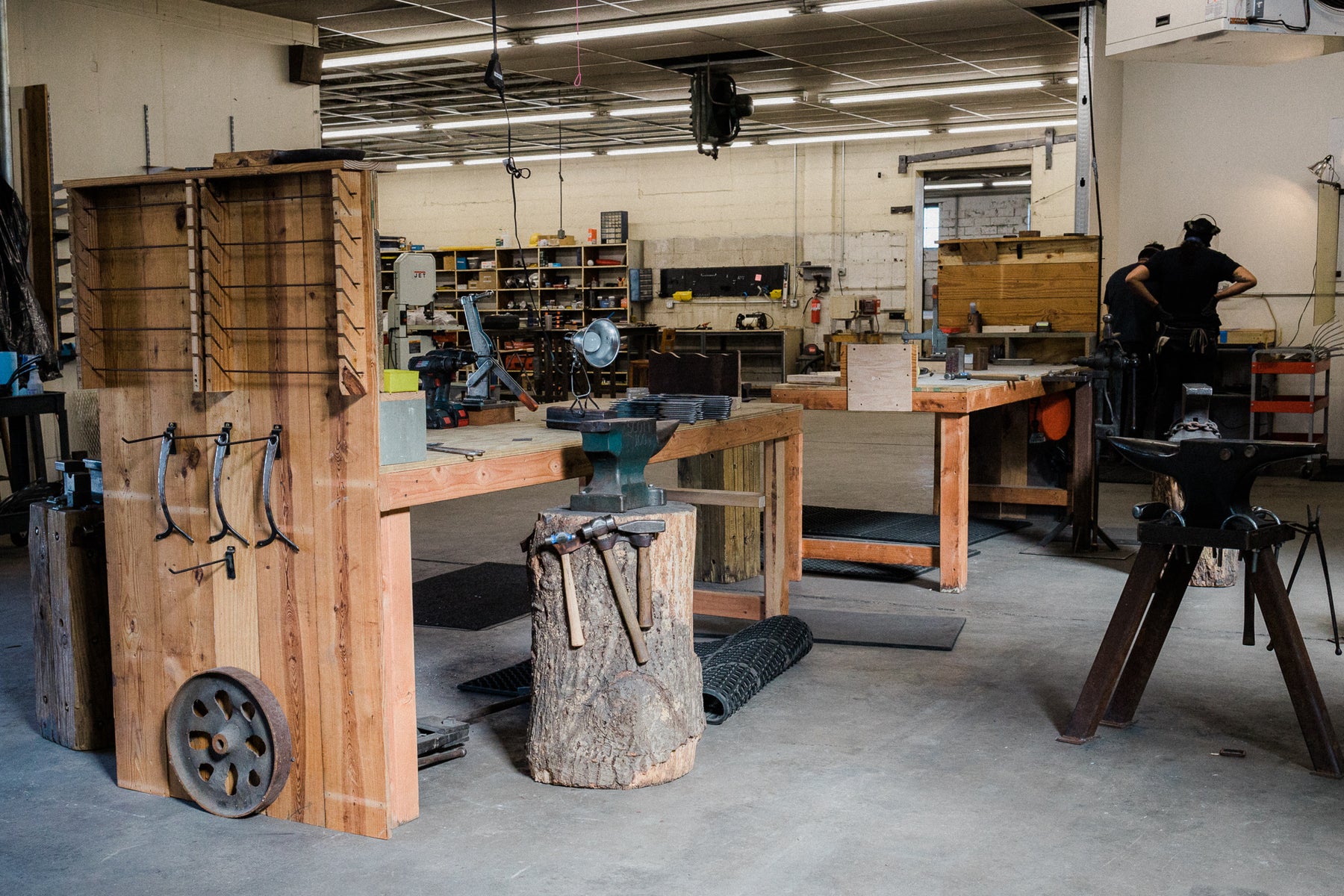 The inside of a blacksmithing shop featuring tools and work spaces