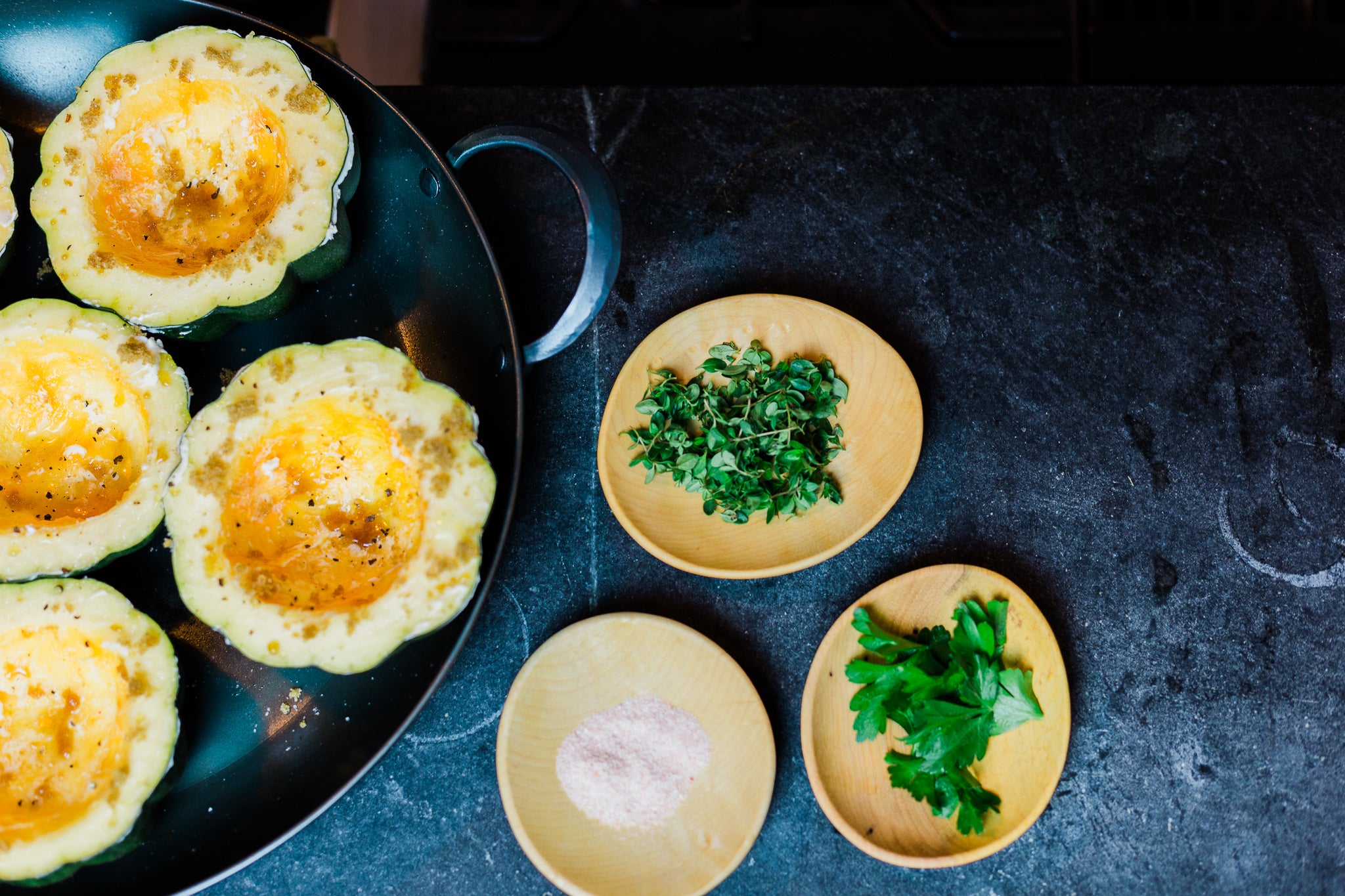 Handcrafted saucier with squash inside and pinch pots alongside with a variety of toppings