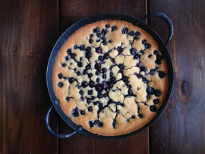 blueberry citrus cake in a carbon steel saucier pan